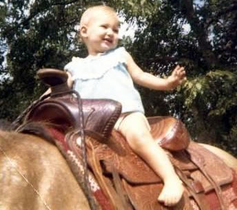 Me riding Sandy when I was pretty young training a horse for a baby to ride